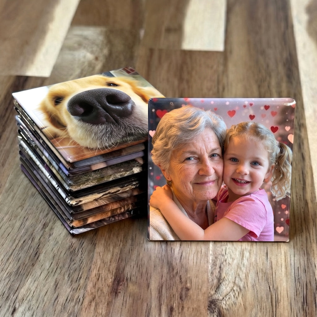 12-Magnet Photo Set — twelve custom 2-inch photo magnets arranged on a wood surface showing varied family memories