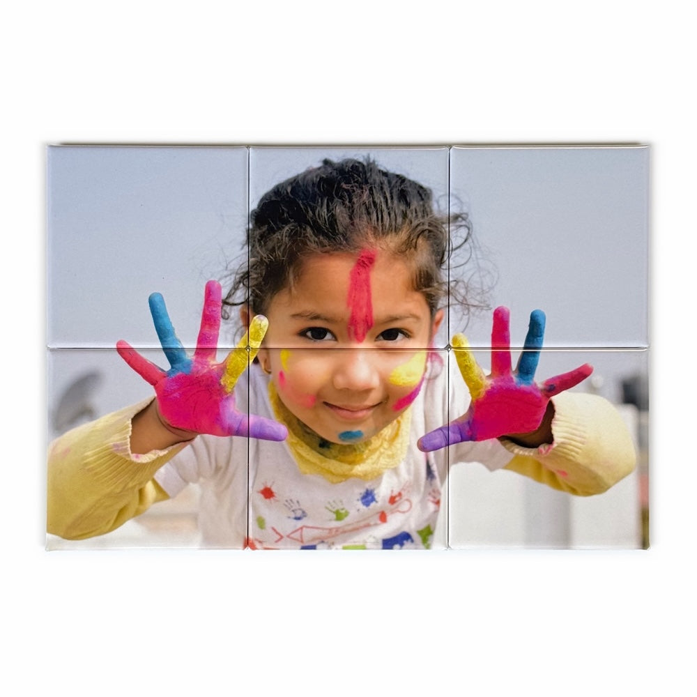 Photo mosaic magnet in a 3x2 landscape grid showing a smiling child with paint-covered hands